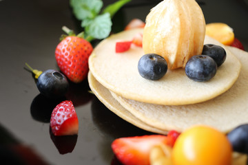 Organic pancake topping with honey, berry and fruit healthy food.