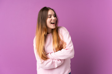 Young caucasian woman isolated on purple background happy and smiling