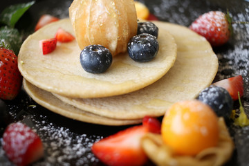 Organic pancake topping with honey, berry and fruit healthy food.
