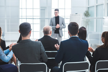 audience applauds the speaker during the business presentation
