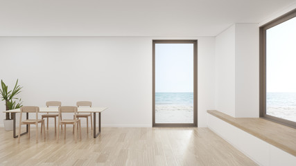 Table on wooden floor of large dining room in modern house or luxury hotel. Minimal home interior 3d rendering with beach and sea view.
