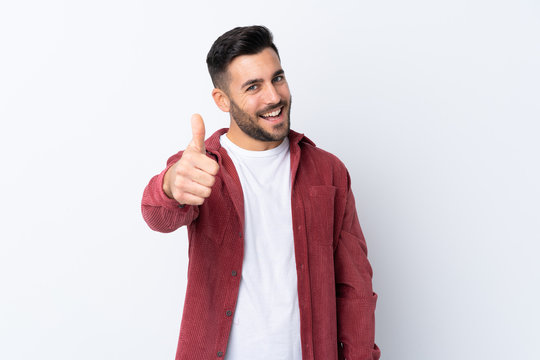 Young handsome man with beard wearing a corduroy jacket over isolated white background with thumbs up because something good has happened