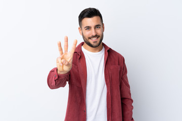 Young handsome man with beard wearing a corduroy jacket over isolated white background happy and counting three with fingers