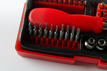 Engineering tools set of various screwdrivers in a box on white background.