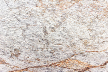 Texture of granite marble stone surface with yellow see through spots.