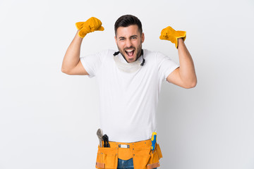 Craftsmen or electrician man over isolated white background celebrating a victory