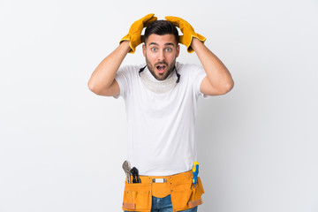 Craftsmen or electrician man over isolated white background with surprise facial expression