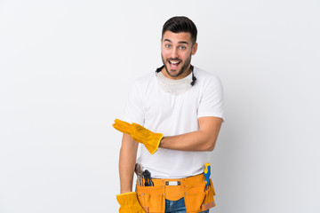Craftsmen or electrician man over isolated white background extending hands to the side for inviting to come