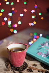 Ceramic coffee Cup, diary and lights. Romantic mood. Breakfast. Lunch