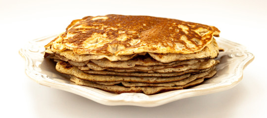 Pancakes side view stack on white color vintage plate isolated on white background close up banner
