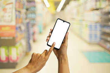 Hand Holding Black smartphone in shoping mall, Blank screen