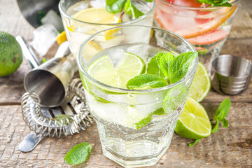 Summer detox beverage  concept. Citrus fruit drinks with ice. Healthy diet cocktail with making bar tools.  Vitamin fortified water