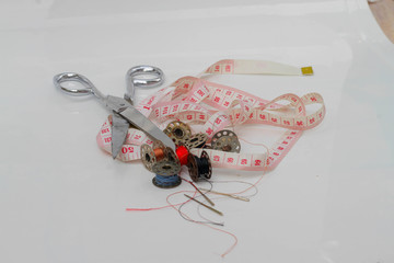 Sewing equipment, tape measure, thread, scissors