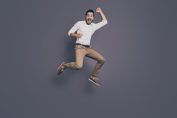 Fototapeta na wymiar Full length photo of young handsome business man jumping high up rejoicing celebrating new startup project success wear white shirt pants footwear isolated grey color background