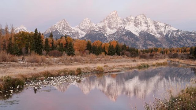 wide sunrise shot of grand teton with early autumn snow at grand teton national park in wyoming, usa
