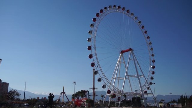 Ferris wheel in Antalya, Turkey. Time lapse. Background blue sky