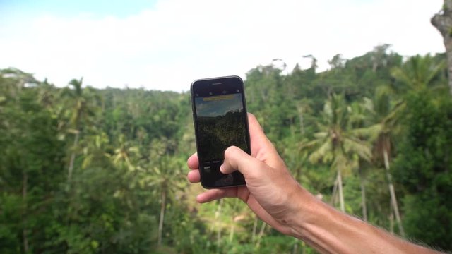 POV on taking picture in rainforest jungle