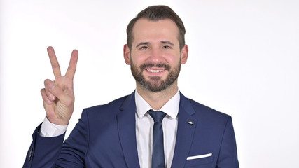 Portrait of Successful Young Businessman showing Victory Sign, White Background