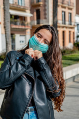 Fototapeta premium Girl with a mask to protect walking on the street