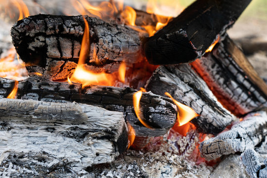 Photo of hot sparking live-coals burning. Orange flame of fire