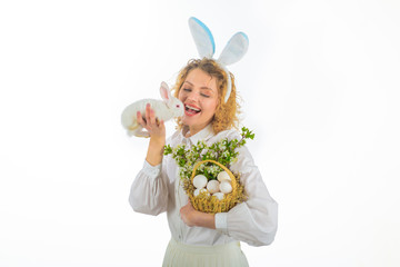 Happy Easter day. Tradition of Easter. Girl in bunny ears holds basket with eggs and Easter bunny rabbit. Religion symbol. Eggs hunt. Easter egg. Bunny. Rabbit ears. Basket with eggs. Spring holiday.
