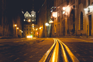 Fototapeta na wymiar Cobble stones old european street with night city lights.
