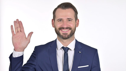 Portrait of Cheerful Young Businessman Waving at the Camera, White Background