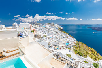 Santorini, Greece. Famous view of traditional white architecture Santorini landscape with blur sea in foreground. Summer vacations background. Luxury travel tourism concept. Amazing summer destination