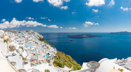 Santorini, Greece. Famous view of traditional white architecture Santorini landscape with blur sea in foreground. Summer vacations background. Luxury travel tourism concept. Amazing summer destination