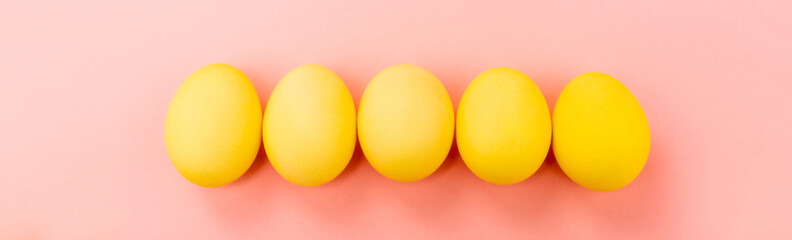 Panoramic view of Easter eggs on pink background, easter concept