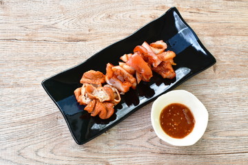 roasted pork neck and innards on plate dipping with tamarind sauce