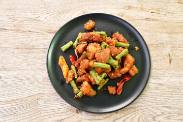 spicy stir fried crispy pork crackling with chili and ginger on plate