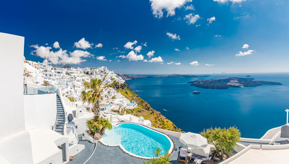 Summer vacation landscape over blue bay seascape. White architecture on Santorini island, Greece. Swimming pool in luxury hotel. Beautiful view on the sea
