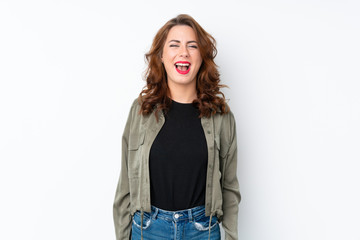 Young Russian woman over isolated white background shouting to the front with mouth wide open