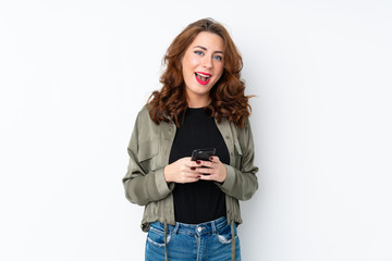 Young Russian woman over isolated white background surprised and sending a message