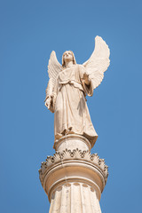 Statue of winged angel at Evangelical church Saint Nikolai at blue sky, Potsdam, Germany, details, closeup