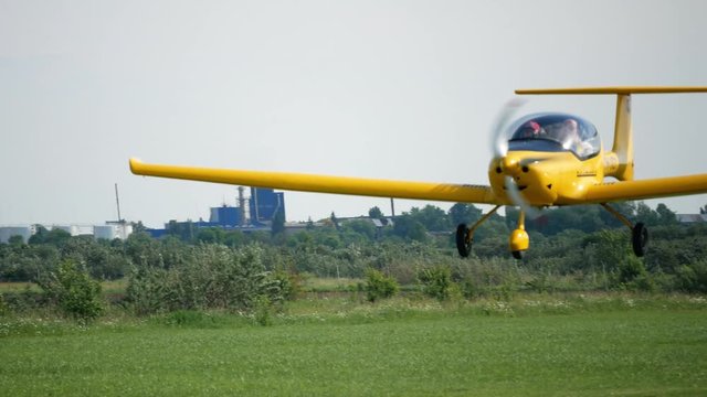 Ultralight small private aircraft airplane flying in the sky over the airfield. Aviation festival holiday at the aerodrome