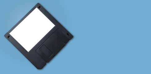 A black floppy disk with white label and blue background.