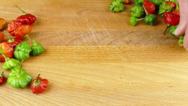 slitting hot chili peppers at preparation of pique sauce, a Puerto Rican hot sauce 4k