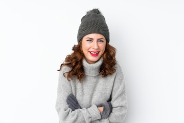 Young Russian woman with winter hat over isolated white background laughing