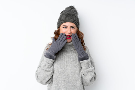 Young Russian woman with winter hat over isolated white background with surprise facial expression