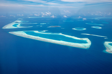 Naklejka na ściany i meble Aerial view of Maldives atolls is the world top beauty. Maldives tourism, luxury travel destination landscape, seascape