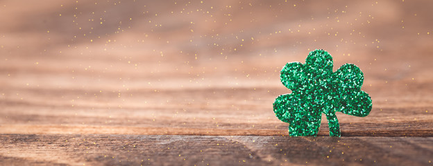 St Patrick's day background with shamrock clover leaf on wood, Irish festival symbol, selective...