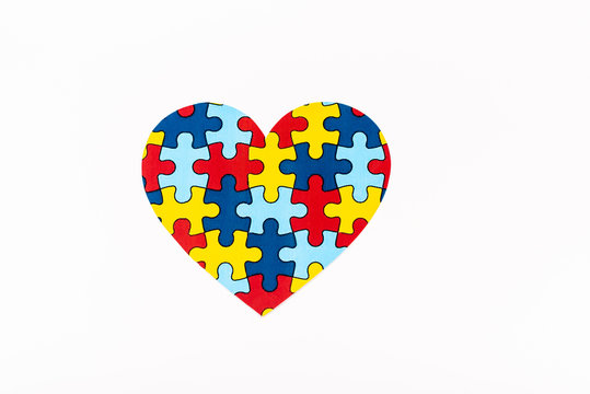 Top view of puzzle heart isolated on white, autism concept