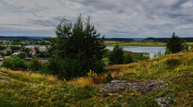Panorama of Karelian nature from a height.Panoramic view of the surroundings of Sortavala from a hill in a city park: a forest of conifers, traces of volcanic lava, rocks and volcanic rocks. Russia