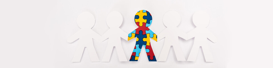 Panoramic view of special kid with autism among another on white