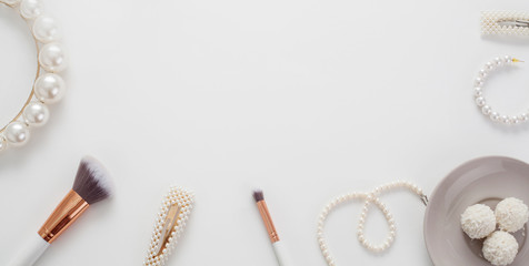 The wedding background with space for text, decorated with invitation envelopes and decorations for the bride, is made in soft pastel colors, with copy space. Conceptual backgrounds for wedding texts.