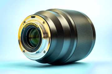 Optical digital camera lens isolated on blue background.