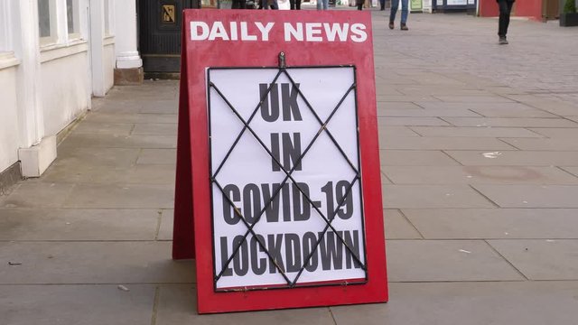 4K: Newspaper Headline Board about The UK being in Coronavirus Covid-19 Lockdown - News stand. Stock Video Clip Footage