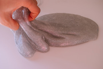 glitter slime transparent flexible viscous. game for children. antistress. hand shakes . beautiful background